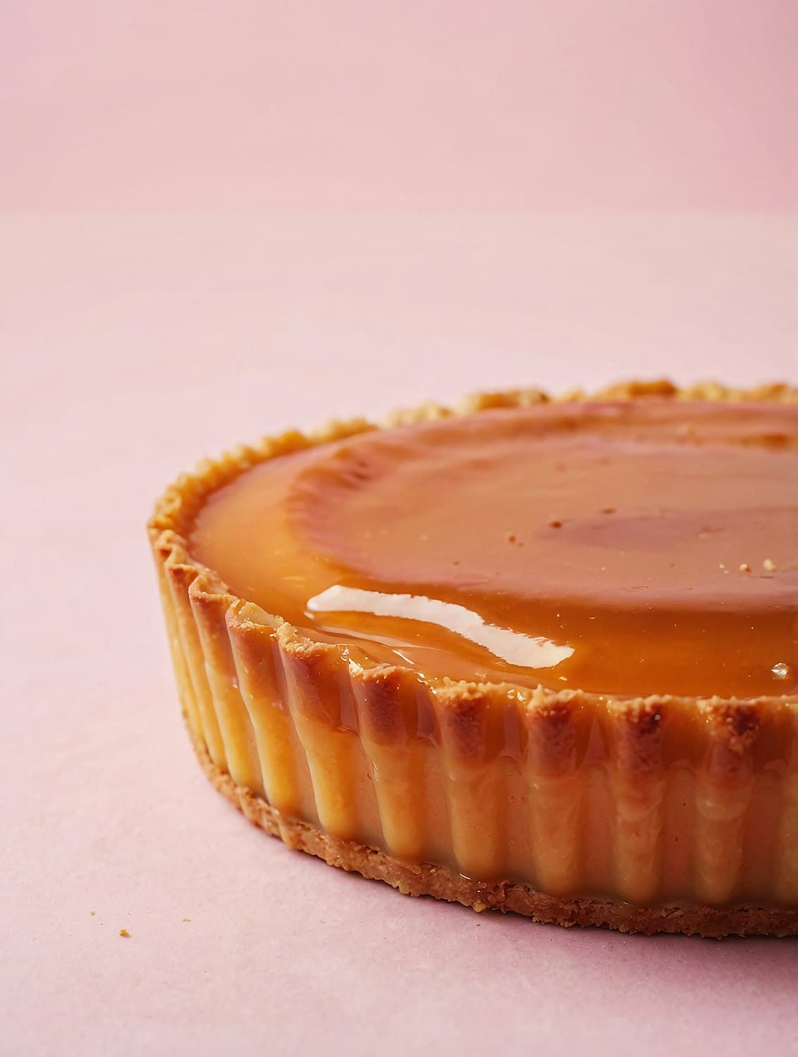 Glossy salted caramel tart in a fluted butter crust